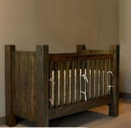 A rustic baby crib made from reclaimed wood