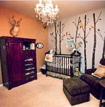 A  nursery decorated in earth tones with a hunting trophy used as wall decorations
