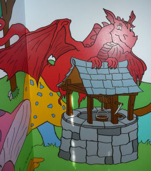 Red dragon tales dragon wall mural art in a baby nursery room