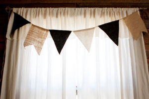 Homemade rustic muslin rod pocket nursery curtains made from a tablecloth