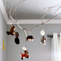 Forest animals theme baby mobile made from a tree branch for the nursery ceiling