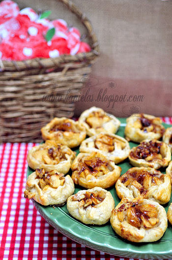 Sliced apples on a plate surround a container of peanut butter dip