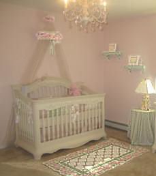 DIY baby bed canopy decorated with a wreath of silk roses in a baby girl nursery room