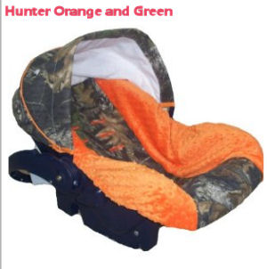 Hunter orange and Realtree Mossy Oak green camouflage baby car seat cover for an infant boy