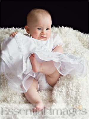 Newborn baby girl photo in white linen christening gown on fluffy chenille background photo props