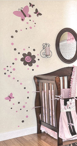 Pink and brown butterfly, polka dots and flower wall decals on the walls of a baby nursery