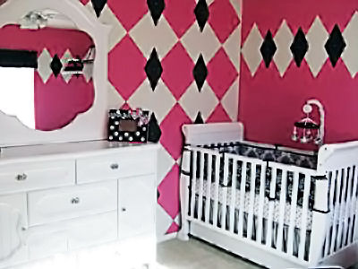 Pink black and white French baby girl nursery with a harlequin accent wall