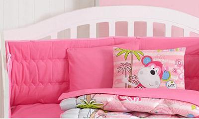 Fun bright pink monkey baby crib bedding and decorations for a girl nursery room.