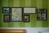 Artwork on the nursery walls includes an ABC letter collage and framed personal photographs